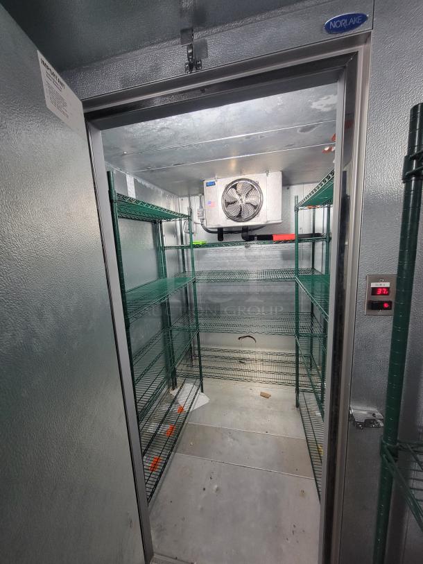Complete Norlake walk-in cooler and freezer combo with condensing unit and green Metro shelving, excellent condition.