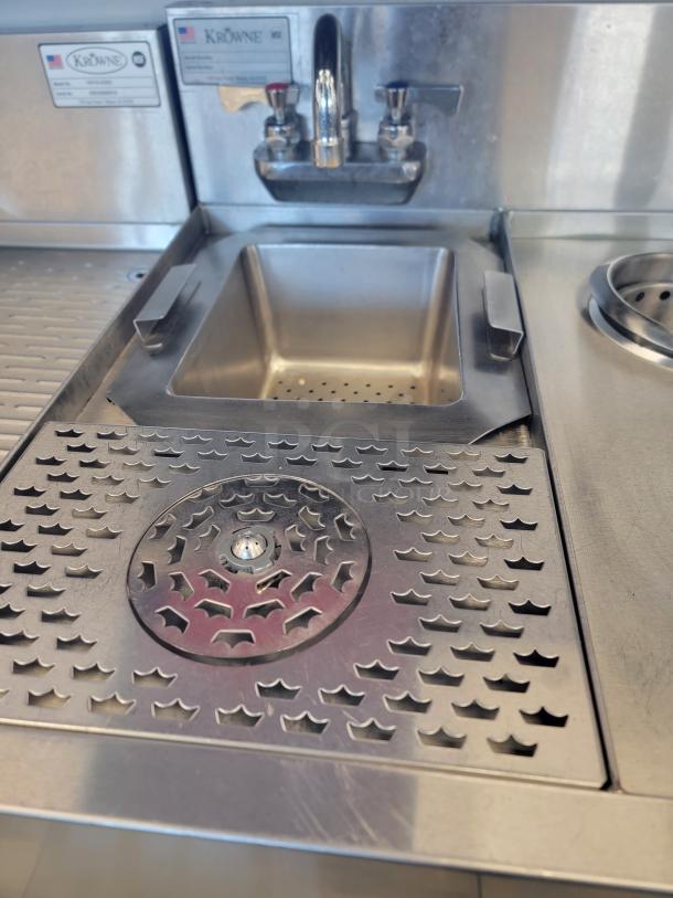 Krowne KR24-MS24 stainless steel underbar station with glass rinser, perforated dump sink, and dipper well with swivel faucet.