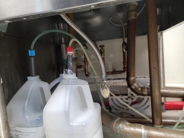 Krowne KR24-MS24 underbar station's plumbing connections and hoses, showcasing its stainless steel build and commercial use.