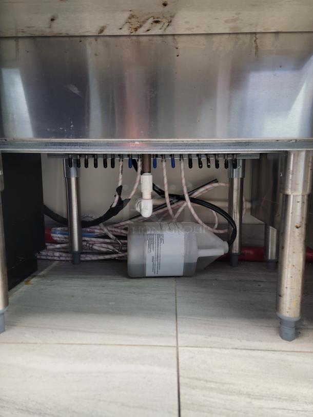 Krowne KR18-24-10 stainless steel ice bin with insulated well and front speed rail, visible plumbing and hoses beneath.