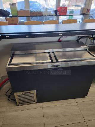 Krowne 48" bottle cooler, model BC48-BG. Black vinyl exterior, stainless steel top, like new condition. Rugged, high-capacity.