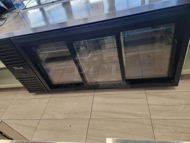True 3-Door Glass Bar Cooler, Model TBR72-RISZ1-L-B-111-1, features stainless steel countertop, bright lighting, excellent condition.