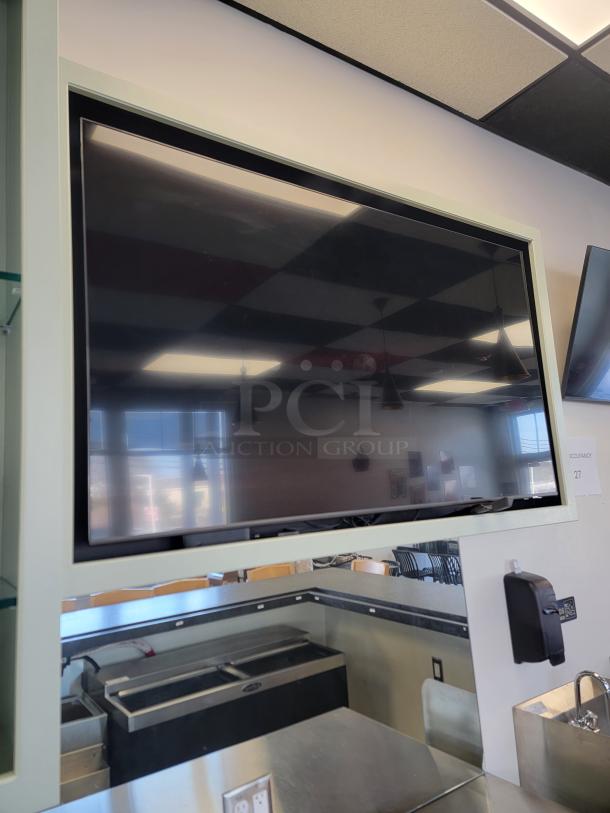 Samsung 65" Smart TV, model UN65TU7000, boundless design, ultra-thin bezels, ideal for restaurants or sports bars.