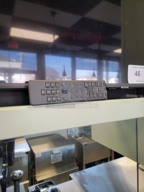 Samsung UN65TU7000 Smart TV with remote, ultra-thin bezel, 4K display, perfect for restaurant or bar digital signage.