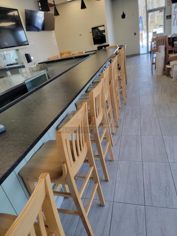 Lot of 24 Richardson Seating wooden bar stools, classic slat-back design, natural finish, commercial-grade, pristine condition.