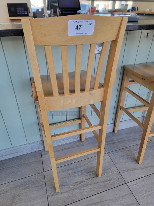 Lot of 24 Richardson Seating wooden bar stools, slat-back design, natural finish, excellent condition, durable for commercial use.