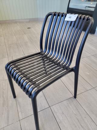 Sleek black slatted bistro chair, commercial grade composite, durable matte finish, ideal for high-traffic areas.