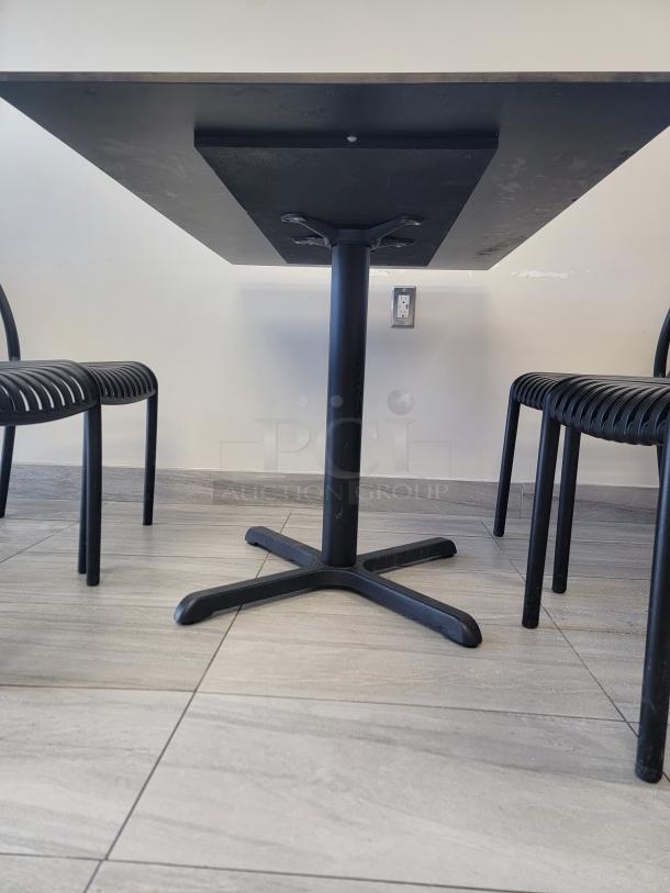 Flash Furniture commercial dining table with charcoal concrete-style laminate top and black cast-iron X-base, durable and modern.