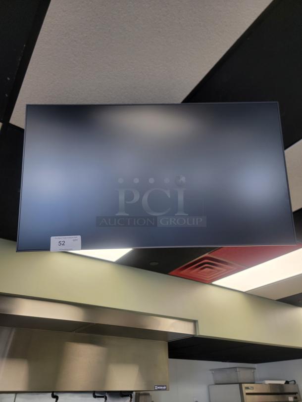 Samsung QM42 menu monitor for auction, commercial-grade, 24/7 operation. Ideal for restaurants. Auction tag visible.