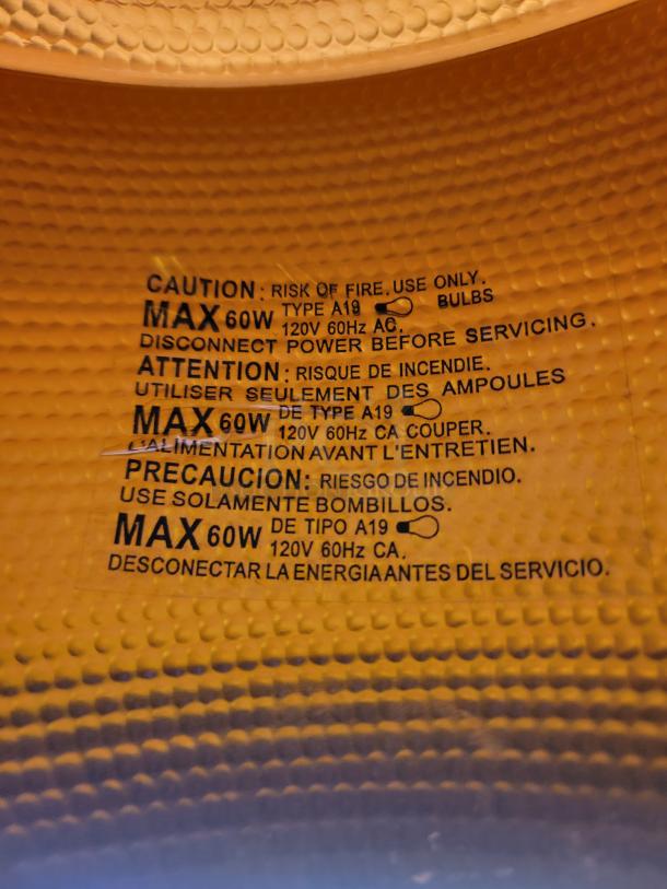 Sleek Mid-Century Modern pendant lights set with matte black finish and hammered gold interior, excellent condition, 60W max bulbs.