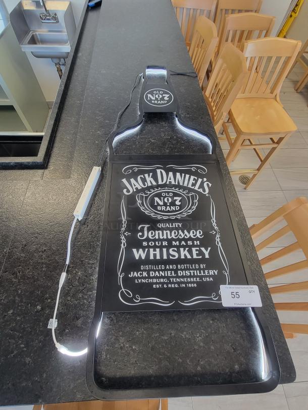 Bottle-shaped Jack Daniel’s LED neon sign, black with white glow, Old No. 7 label, includes power supply, ready to hang.