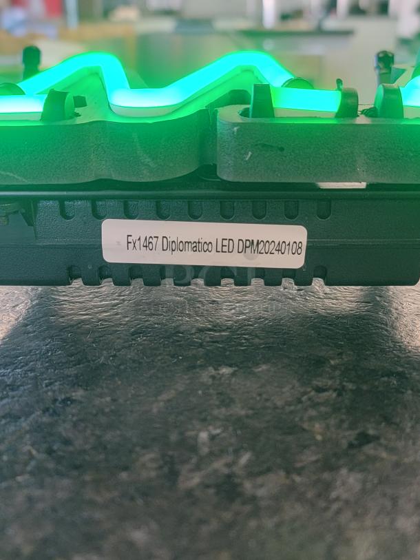 Glowing Diplomático Rum LED sign, model Fx1467 DPM20240108. Emits vibrant green. Lightweight, energy-efficient bar decor.