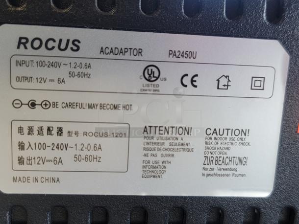 Back of Rocus Diplomatico Rum LED sign showing adapter details. Includes input-output specs, safety warnings, and manufacturer info.