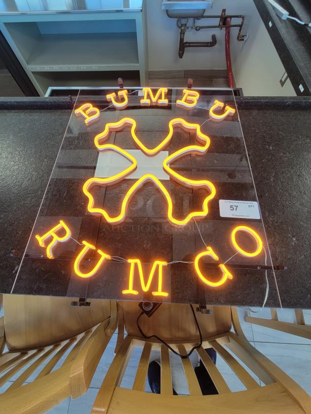 Rare Bumbu Rum Co. LED neon sign with orange glow and Caribbean "X" logo on clear acrylic, includes dimmer control.