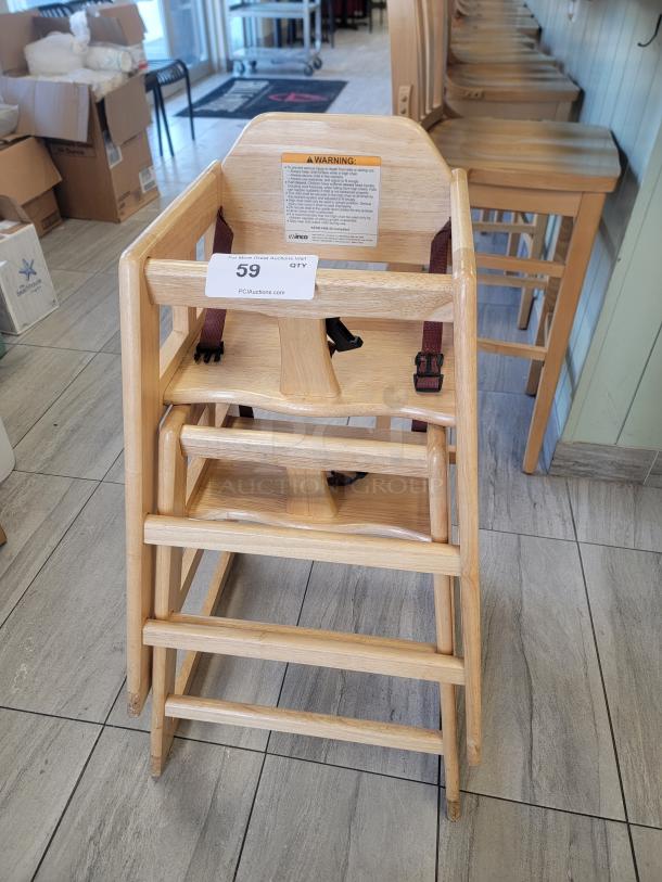 Set of 2 Winco CHH-101 wood high chairs, natural finish, stacking design, safety straps, ideal for home or restaurant use.