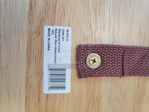 Winco CHH-101 high chair label on natural wood, showing model and origin. Safety strap with metal screw visible.