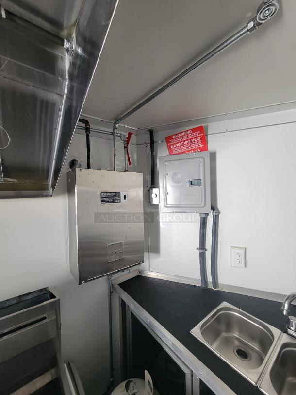 Interior of 2021 Covered Wagon mobile food trailer with Ansul fire system, stainless steel counter, and integrated sink.