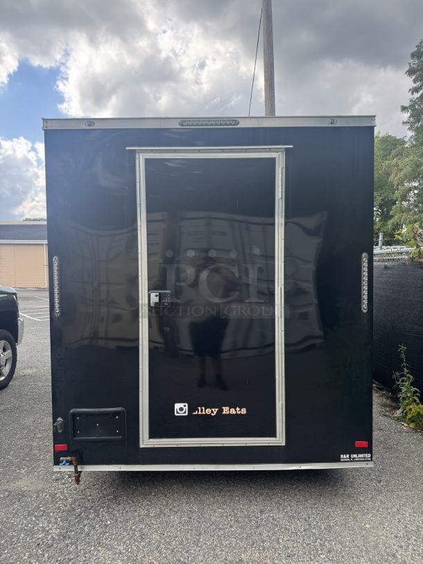 2021 16-foot Covered Wagon mobile food trailer, black exterior, rear view, with "alley Eats" logo and keypad on door.