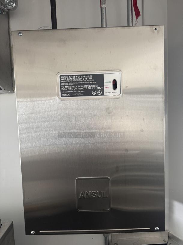 Ansul R-102 fire suppression system panel, stainless steel finish, labeled with manual and automatic actuation instructions.