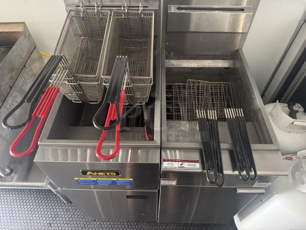 Dual Anets SLG40 fryers in a 2021 Covered Wagon mobile food trailer with baskets, part of a full commercial kitchen.