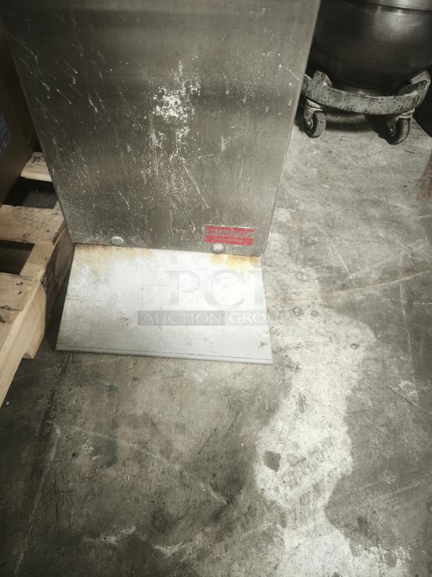 Palazzolo GS-1 Cheese Shredder on rolling stand, visible wear, metal construction, Palazzolo label on base, industrial use.