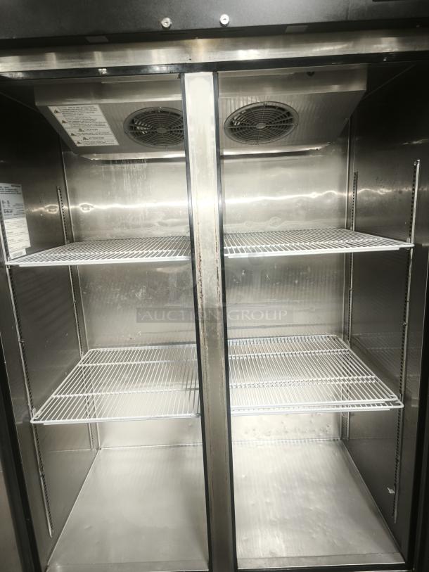 Turbo Air M3F47-2-N reach-in freezer with two solid doors, shelves, and fan vents. Clean interior, visible safety labels.