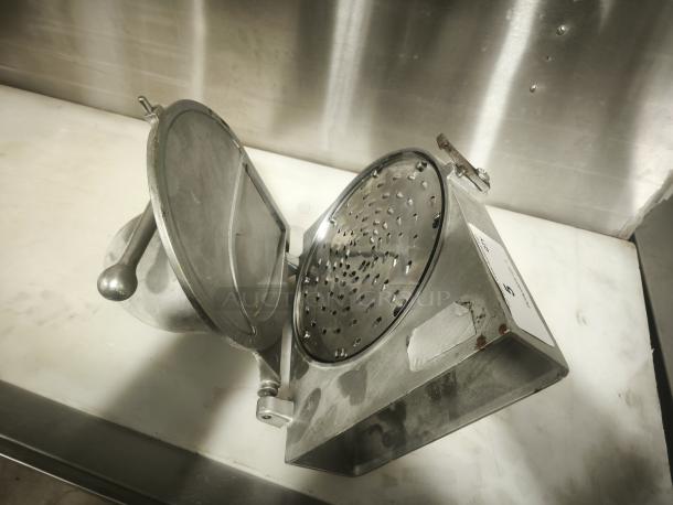Hobart Pelican Head cheese shredder mixer attachment with shredding blade, metal body, visible wear.