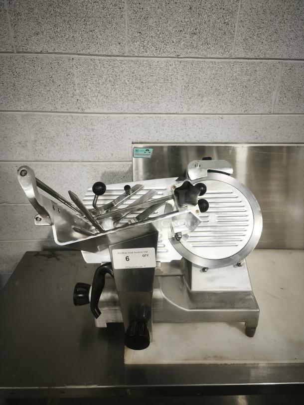 Patriot meat slicer with 10″ blade, stainless steel, excellent condition, features manual controls and adjustment knobs.
