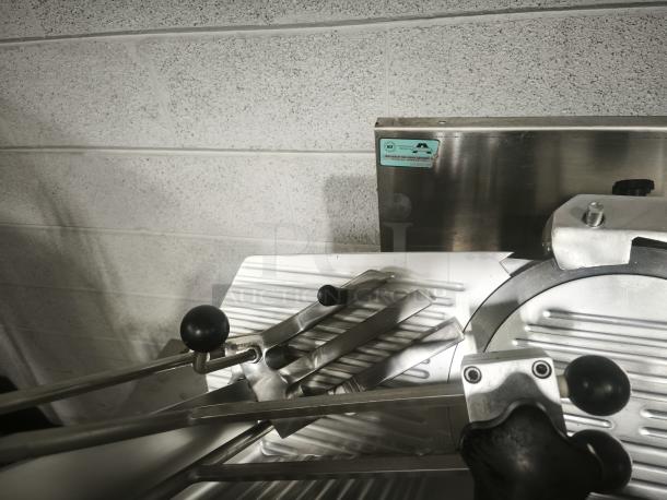 Patriot 10" meat slicer with stainless steel construction, black handle, visible adjustment knobs, and certification label.