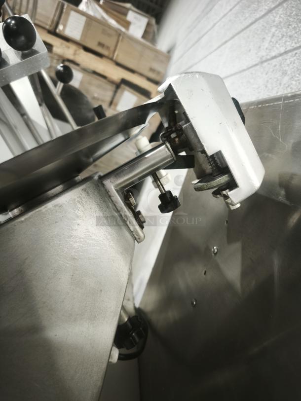 Patriot meat slicer with 10″ blade, metal construction, side view. Appears in good condition with visible adjustment knobs.