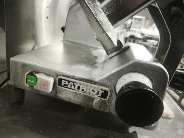 Patriot meat slicer with 10" blade, featuring a visible on/off switch and size adjustment dial. Used condition.
