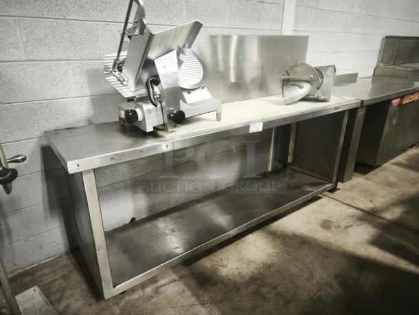 Stainless steel prep table with lower shelf, good condition, includes mounted slicer and attachment on table top.