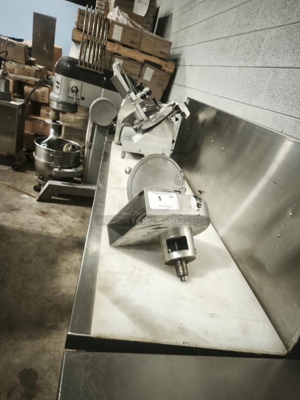 Stainless steel prep table, good condition. Features a durable surface and storage below. Includes attached equipment.