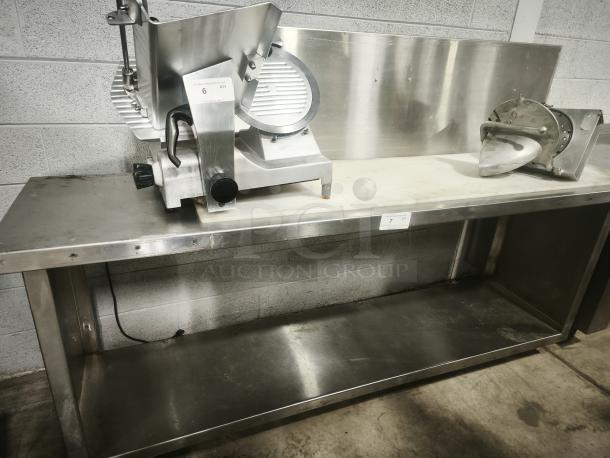 Stainless steel prep table with attached slicer in good condition, showing slight wear, ideal for commercial kitchens.