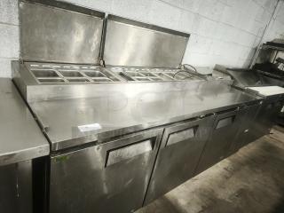 True TPP-93 93" refrigerated pizza prep table with 3 doors, stainless steel, multiple ingredient bins, in good condition.