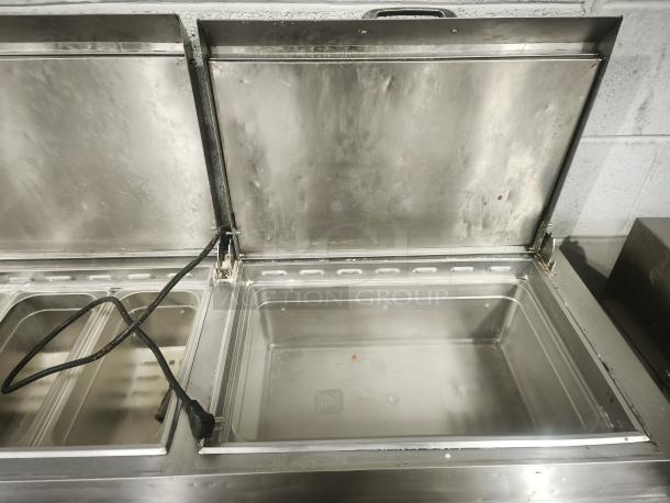 True TPP-93 refrigerated pizza prep table, 93" wide, three-door, stainless steel, visible wear, clean interior.