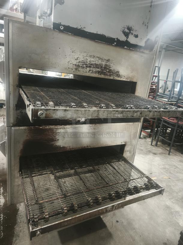 Middleby Marshall PS360 double stack gas pizza oven with conveyor. Used condition, stainless steel, shows wear and discoloration.
