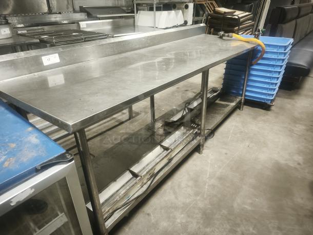 Stainless steel prep table, 95x31x36 inches, sturdy, industrial-grade. Includes undershelf, moderate wear. Ideal for kitchens.