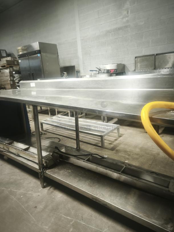 Economy stainless steel prep table, 95x31x36 inches, sturdy construction, clean condition, ideal for kitchen use.