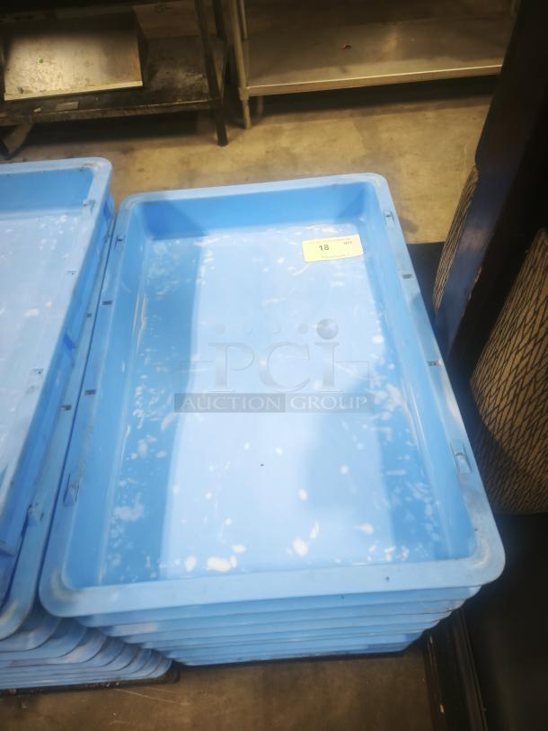 Blue stackable fiberglass tanks, plastic utility totes, moderate wear, visible white spots, label indicates quantity 18.