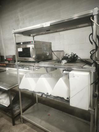 Heavy-duty steel shelving unit, three-tier, commercial-grade, holds kitchen equipment. Visible labels: "20" and "25."