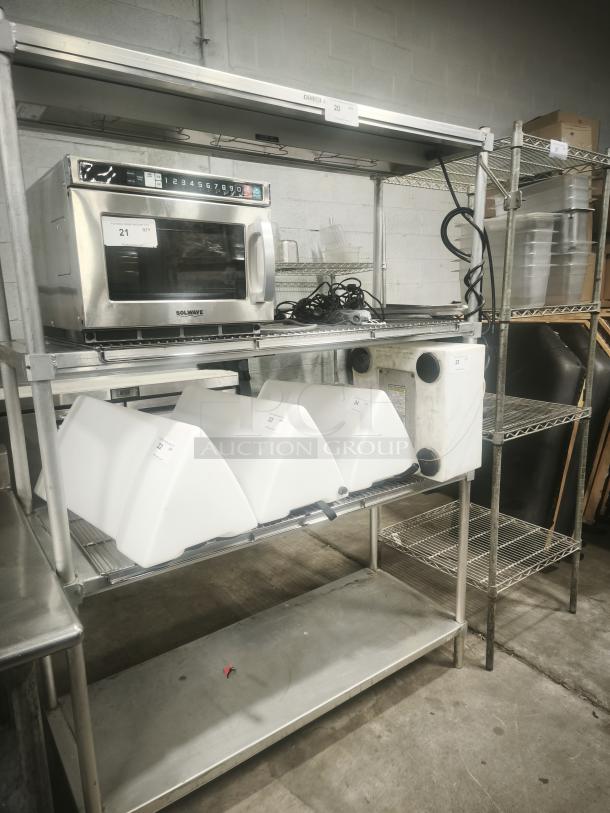 Heavy-duty three-tier steel shelving unit, used, with sturdy wire shelves and visible product labels.