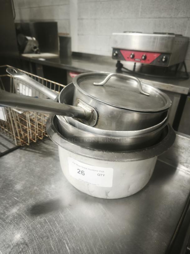 Stainless steel saucepans with lids, various sizes, good condition. Auction tag reads "26 QTY". Suitable for kitchen use.