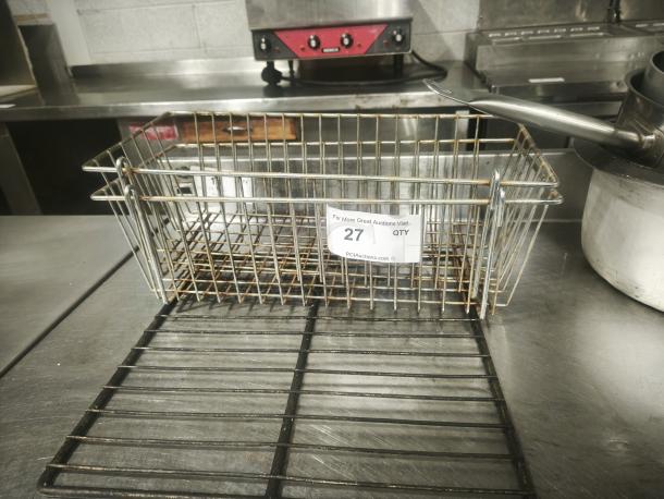 Commercial-grade wire basket, stainless steel or chrome-plated, rectangular, good condition, auction tag "27 QTY" attached.