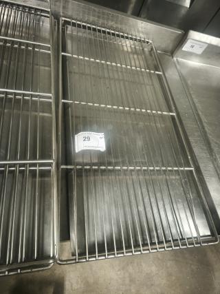Commercial stainless steel wire racks in good condition, shown with auction tag number 29. Ideal for storage or display.