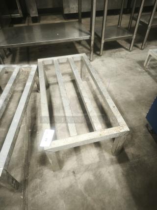 Aluminum dunnage rack for commercial storage, used condition, sturdy construction, visible tag marked "44".