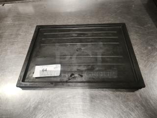 Black plastic tray or lid, multi-purpose, rectangular with ridges. Visible sticker with auction info. Good condition.