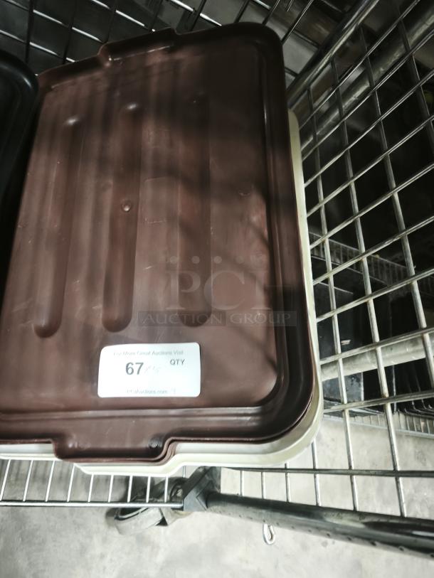 Brown plastic commercial bus tub lid on metal rack, good condition, auction label reads "67 PCS QTY".