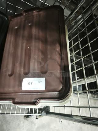 Brown plastic commercial bus tub lid on metal rack, good condition, auction label reads "67 PCS QTY".