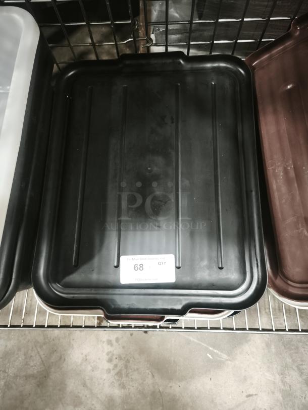 Black plastic commercial bus tub lid, gently used, with a quantity label marked "68" visible on the surface.